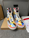 Loubouti'* latest red-soled canvas shoes