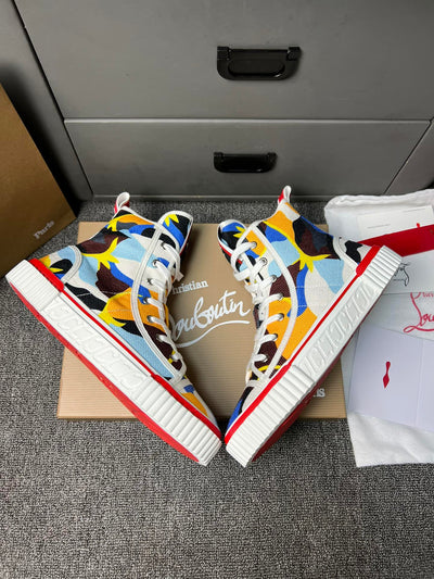 Loubouti'* latest red-soled canvas shoes